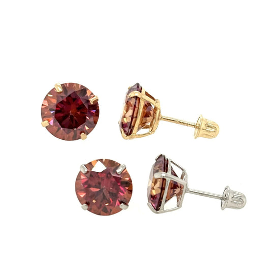 Four pairs of red gemstone earrings in gold and silver on a white background