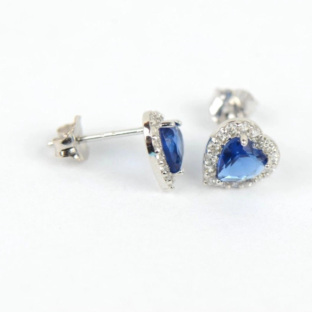 Heart-shaped blue gemstone earrings on a white background