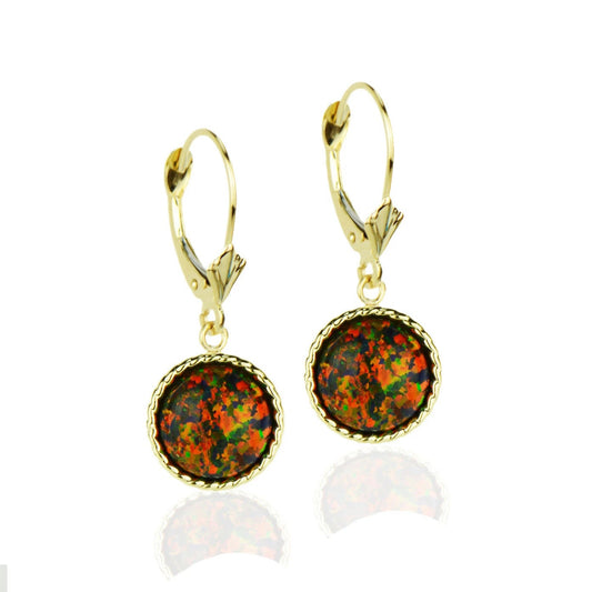Gold earrings with round opal stones on a white background